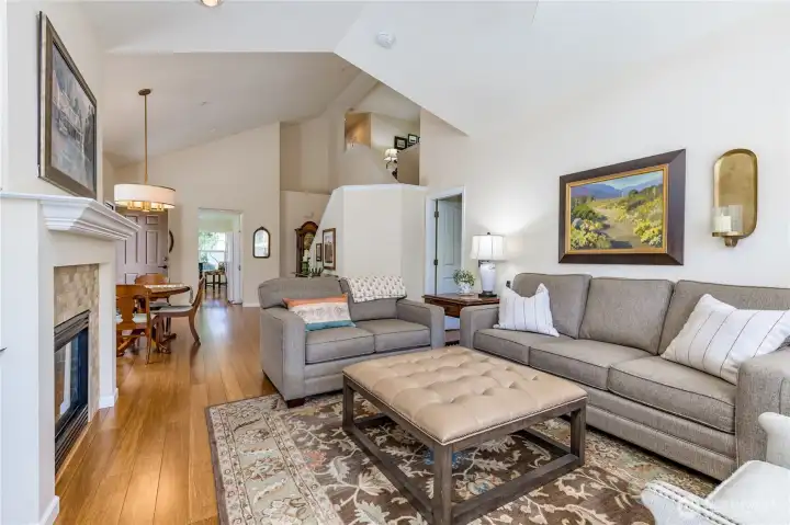 Inviting living room boasting vaulted ceilings and a classic fireplace.