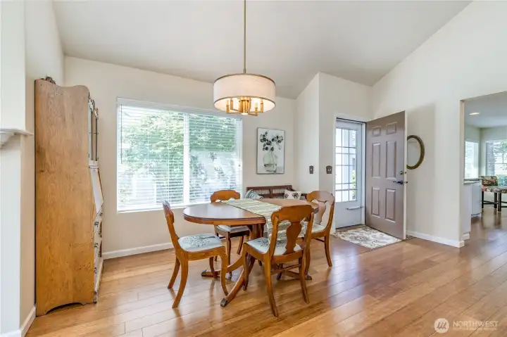 Another view of the dining area showcasing the gorgeous bamboo floors and entry.
