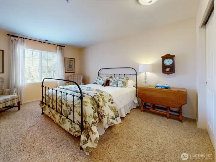 A bright and cozy upper-level bedroom, perfect for guests, family, or a secondary suite.