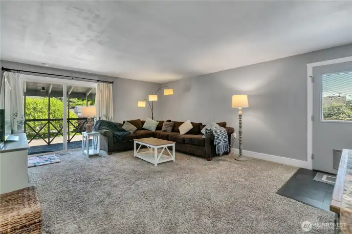 Large living room. Door leads to backyard and sliding door leads to covered side porch