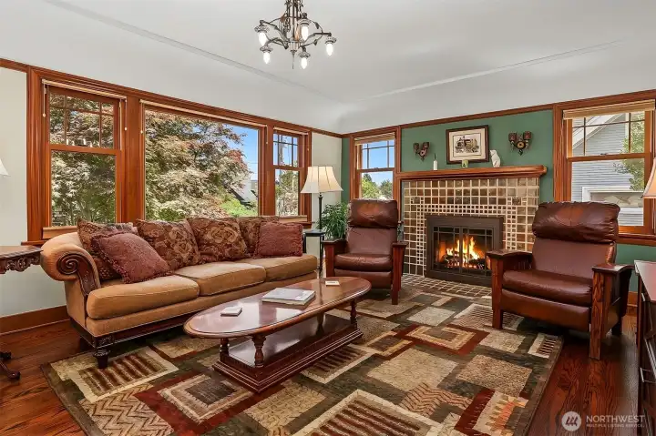 Gorgeous wood wrapped pivot style windows throughout the first and second floor. Beautiful Art Deco tile fireplace is a focal point in the Living Room. Gorgeous wood wrapped pivot style windows throughout the first and second floor. Beautiful Art Deco tile fireplace is a focal point in the Living Room.