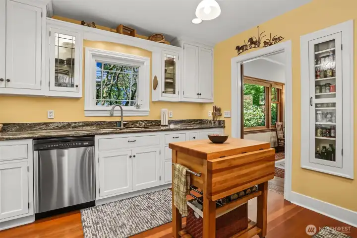 Shaker style cabinetry and stainless appliances with a handy original feature of a built-in spice rack. Shaker style cabinetry and stainless appliances with a handy original feature of a built-in spice rack.