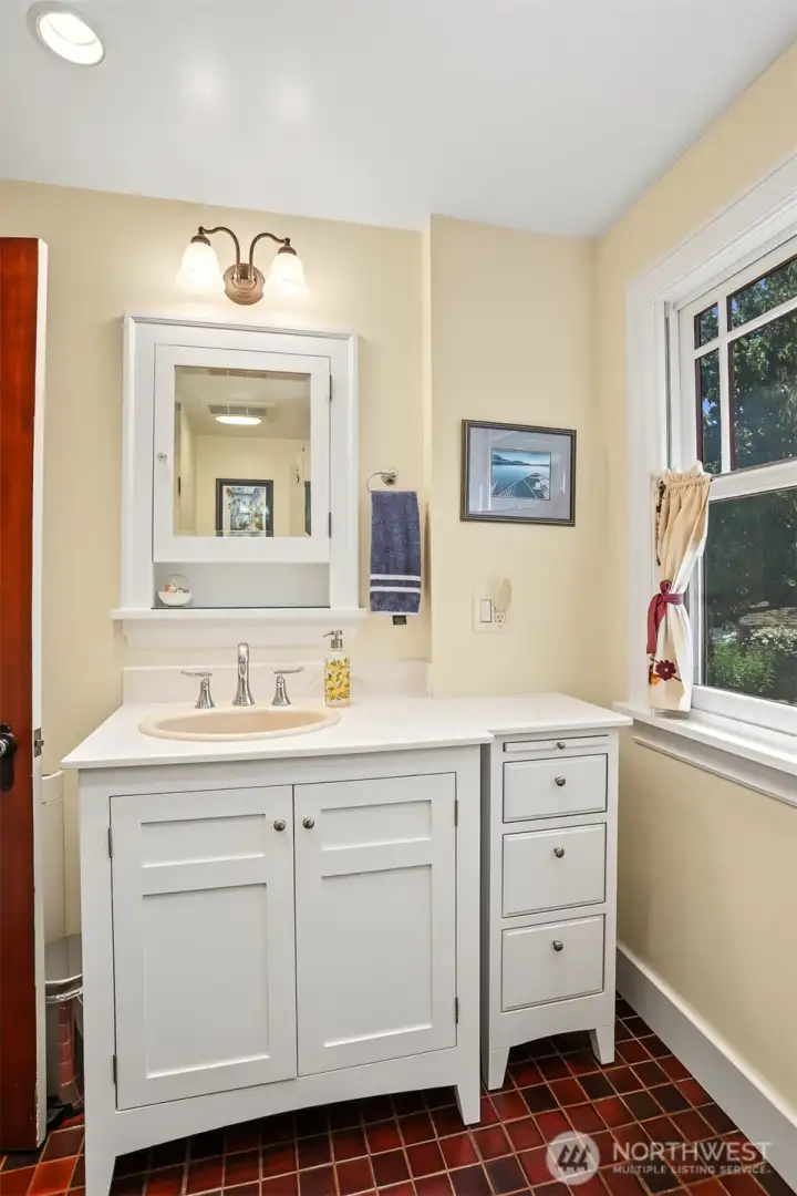 The main floor bathroom has been remodeled with shaker cabintry and ceramic tile flooring. The main floor bathroom has been remodeled with shaker cabintry and ceramic tile flooring.