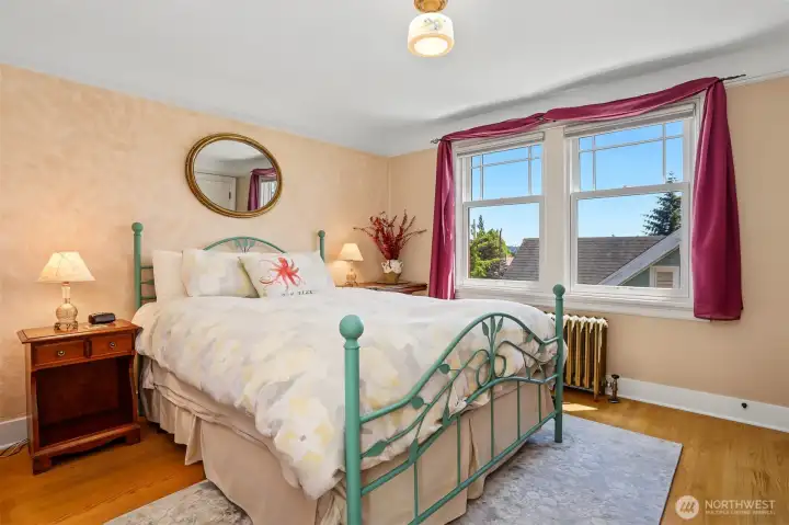 Second floor bedroom has hardwood floors and a peak-a-boo view of the Space Needle and partial Mt. Rainer. Second floor bedroom has hardwood floors and a peak-a-boo view of the Space Needle and partial Mt. Rainer.