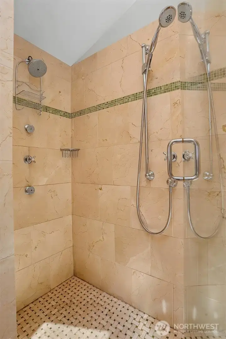 Spa style shower with dual heads and body jets. Artisan tile work with Crema Marfil marble. Spa style shower with dual heads and body jets. Artisan tile work with Crema Marfil marble.