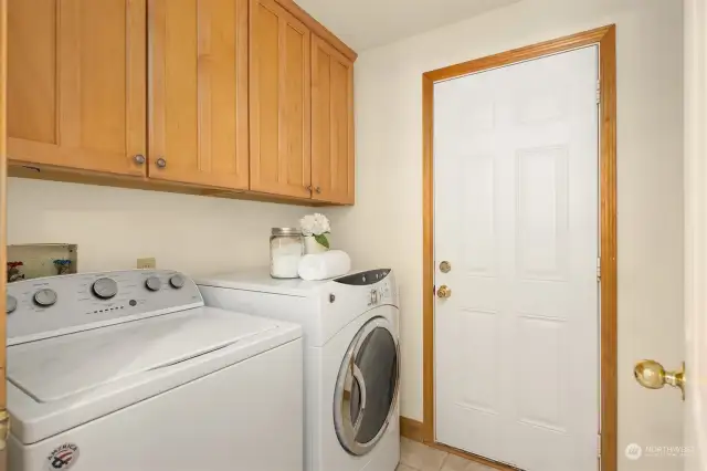 The utility room is just off the kitchen and connects to the garage.
