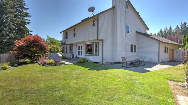 This yard will be the place to be this summer with all this grassy space and two patios!