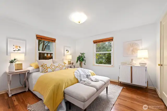 The largest of two bedrooms on the main level can easily accommodate a king size bed. Hardwood floors and large closet, wood slatted blinds and garden views.