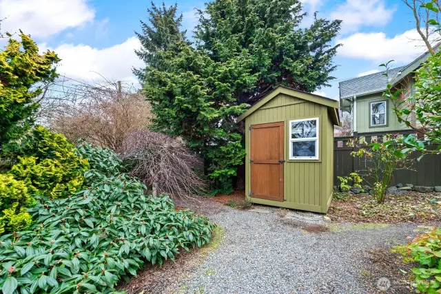 Tidy garden shed holds your tools and toys. To the left is an area which could be developed into a parking space with alley access.