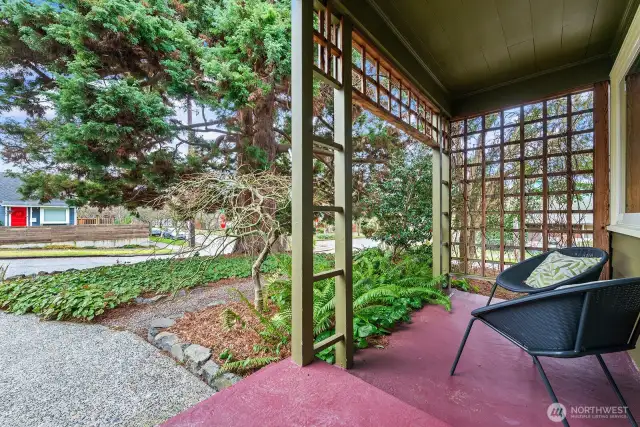 Protected from the weather, the front porch is a lovely place for morning coffee and a view of this quiet neighborhood.