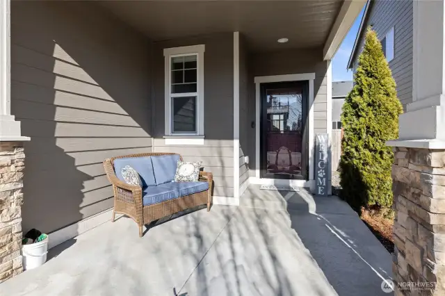 Very welcoming front porch with storm door