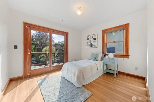 Bright and versatile, this inviting space features period-matching Marvin double-pane windows and elegant French doors that open directly to the Azek deck—perfect for morning coffee, fresh air, or easy indoor-outdoor living.