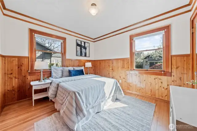 Bedroom #3: Warm and inviting, this charming room showcases rich wood wainscoting, multiple windows that fill the space with natural light, and plenty of room to relax, work, or unwind.