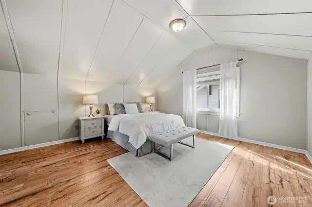 Welcome to your spacious upper-level Primary Suite—an ideal retreat for rest and relaxation. This light-filled suite offers plenty of room to unwind; make sure to look at those wall storage compartments cleverly tucked away for hidden organization.
