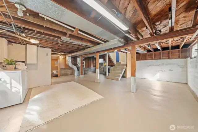 Tucked away you'll find a convenient ¾ bathroom and a finished flex space complete with a kitchenette and cozy wood-burning fireplace—ideal for a rec room, guest retreat, or bonus storage with endless potential.