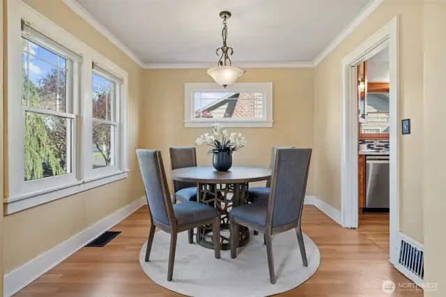 This spacious dining room is filled with abundant natural light, thanks to period-matching Marvin double-pane windows. Designed with both charm and function in mind, it offers a warm, welcoming setting for everyday meals or entertaining. The open layout flows seamlessly into the living room and kitchen—perfect for connected, comfortable living.