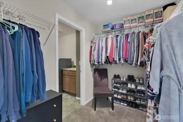 Primary walk in closet. connected to laundry