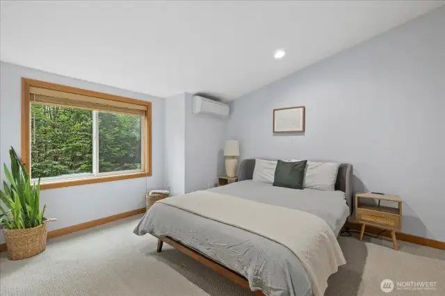 Primary bedroom with vaulted ceilings and minisplit