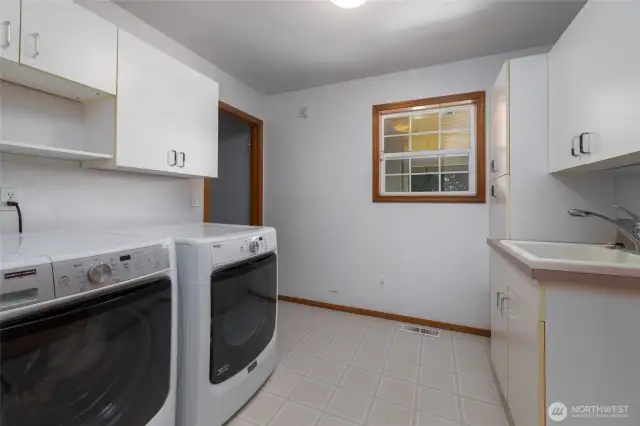 Lower level has dedicated laundry room with utility sink and storage.
