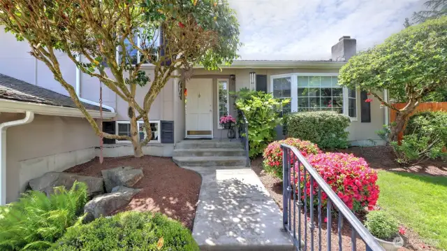 Beautifully lined walkway with lush and mature landscaping to greet you and your guests.