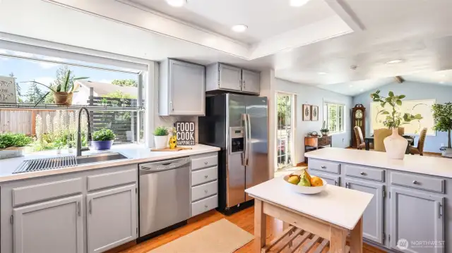 Generously deep stainless steel farmhouse sink makes cleanup stylish and simple.