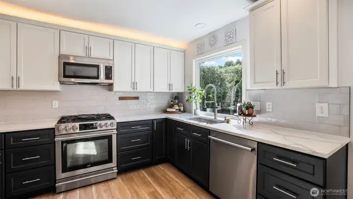 A chef’s dream with gas range, updated cabinetry, and clean, contemporary finishes.