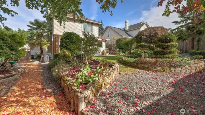 Charming garden pathway framed by lush landscaping and vibrant greenery.