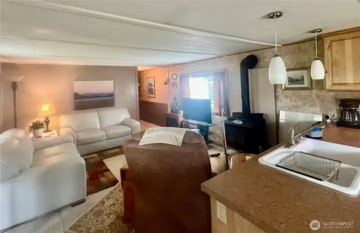 Well furnished  Living area is open to kitchen.  Cozy wood stove