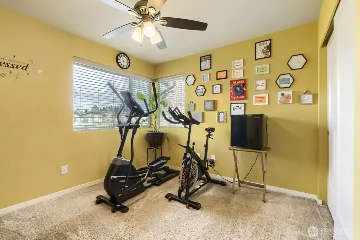 Upper-level bedroom #1, currently used as an exercise space—easily adaptable to suit your needs, whether as a bedroom, home gym, or creative retreat.