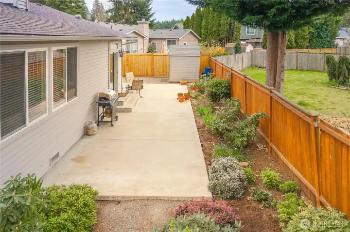 Great patio surrounded by beautiful planning beds.