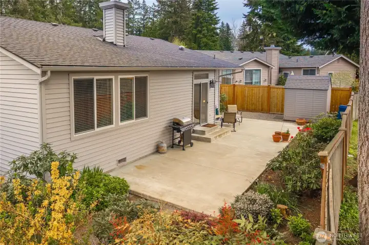 Great patio surrounded by beautiful planning beds.