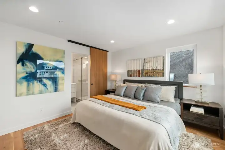 The primary suite with spa-like bath, walk-in closet, and custom sliding door.