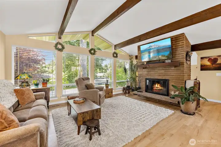 Large windows that fill the space with natural light, and beautiful hardwood floors that tie the room together with warmth and character.