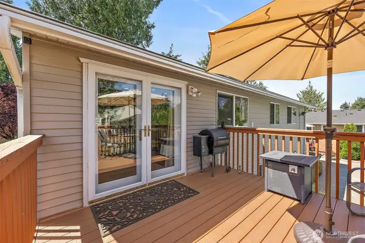 A nice Trex deck located just off the dining area extends your living space outdoors. The French doors offer easy access and a welcoming entry point for family and guests enjoying the pool area below.