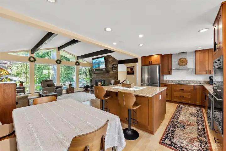 Viewed from the French doors, this spacious gathering area highlights the home's open-concept design. Perfect for entertaining, it creates a welcoming atmosphere where family and friends can easily interact while enjoying seamless connectivity between the main living spaces.