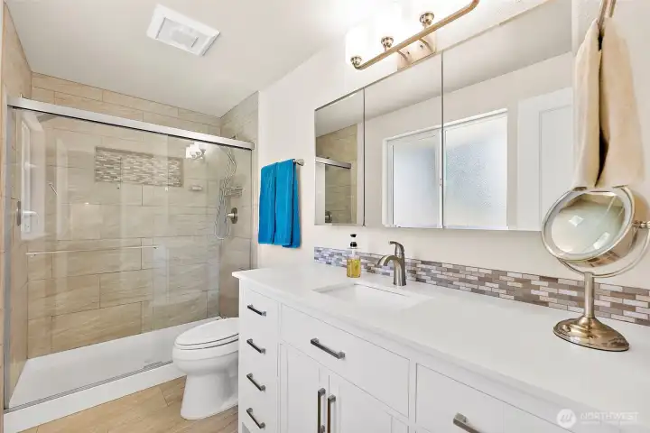 Updated in 2020 the primary suite offers shower with full tile surround, modern vanity & medicine cabinet style mirrors for extra storage options.