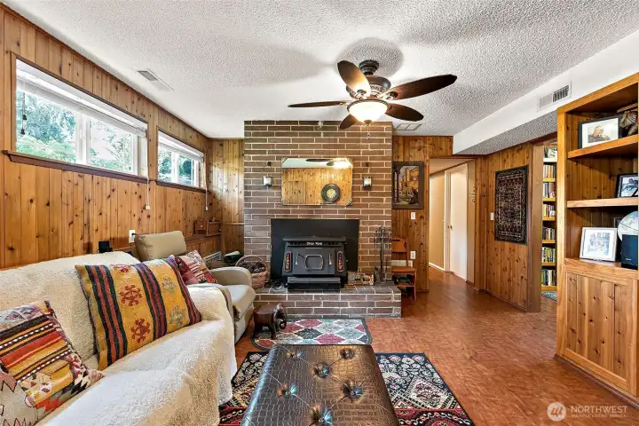 Lower level bonus room with brick hearth & wood burning fireplace