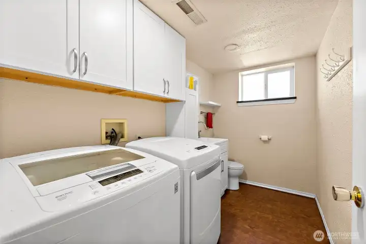 Lower level laundry room with plenty of extra storage + 1/2 bath!
