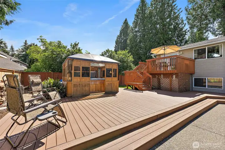 Two tiered Trex deck off the deck staircase- perfect place for sunbathing or just relaxing with a cool summer beverage.