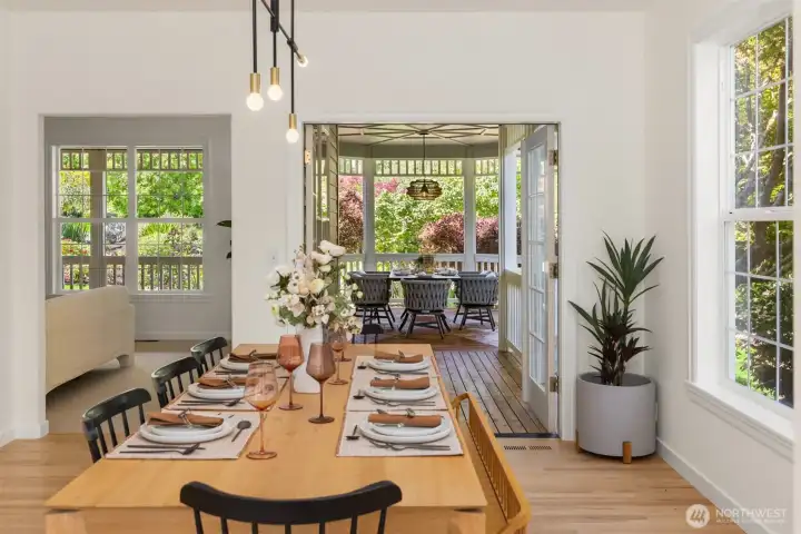 Open up the french doors to the wrap around porch and outdoor dining