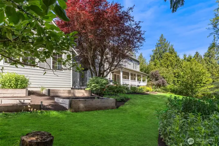 Garden beds behind and to the side of the detached grarage/studio