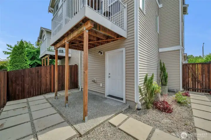 Back yard with door to the garage.