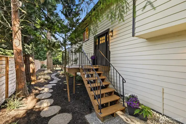 Stairs on the side of the home to the front door.