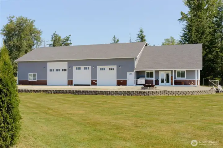 Concrete block retaining wall separates parking and fire pit areas from lawn. Concrete block retaining wall separates parking and fire pit areas from lawn.
