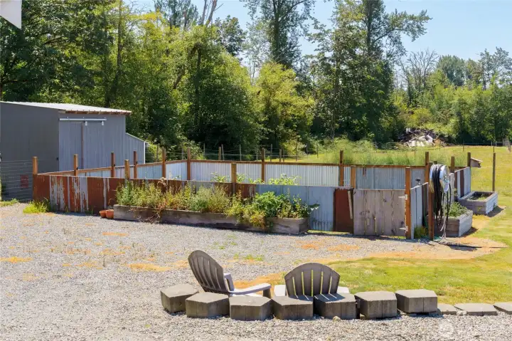 Raised garden beds around perimeter of fenced garden area. Yard hydrant at corner. Raised garden beds around perimeter of fenced garden area. Yard hydrant at corner.