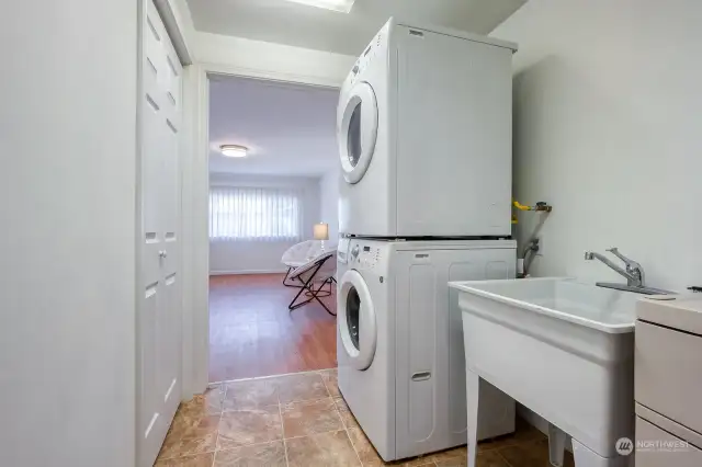 Laundry area with utility tub. Front load washer/dryer included.