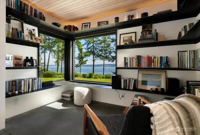 The library nook with a corner window, perfectly framing the stunning corner view of Mount Baker over Saratoga Passage.