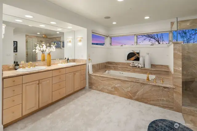 Marble surround soaking tub and shower offer the ultimate spa experience.