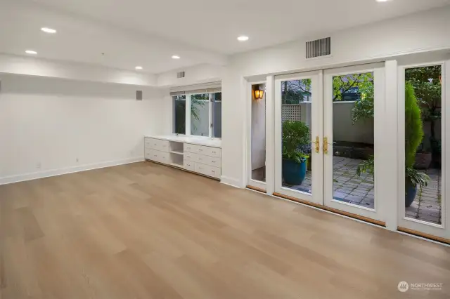 Large living space with built ins opens to it's own patio.