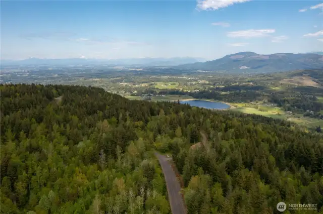 Aerial View looking at Squalicum Lake, Valley, with the Canadian Coastal Mountain range in the distance